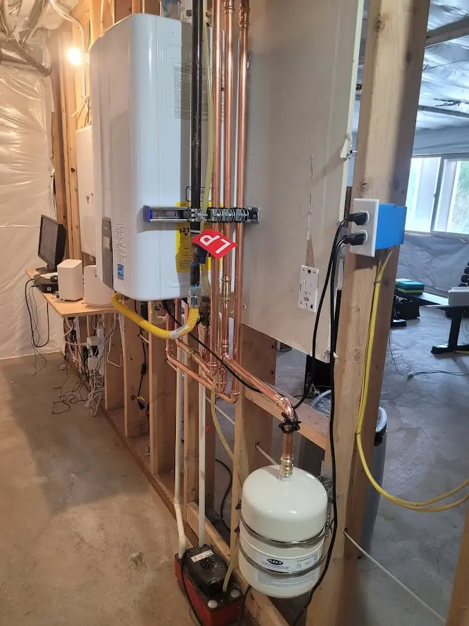 Licensed plumber repairing a kitchen sink in Plainview